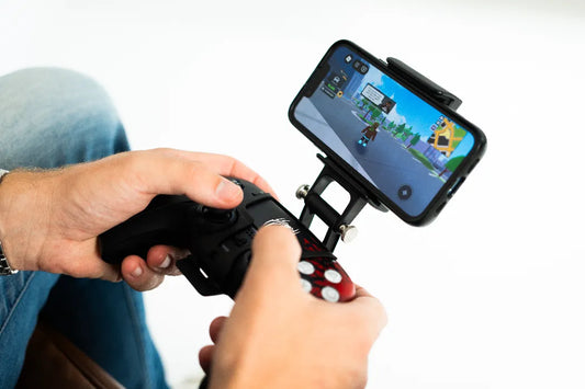 Gamer holding Game Armour mobile mount with synced PS5 Spiderman controller playing Roblox on phone